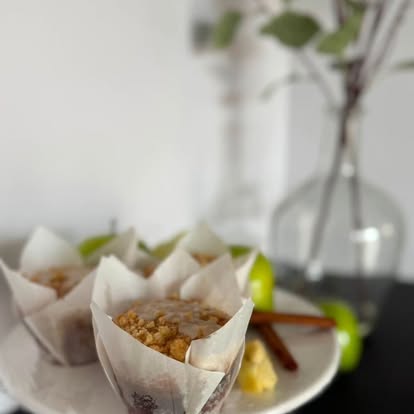 Fruit crumb muffins in tulip wrappers on a white plate